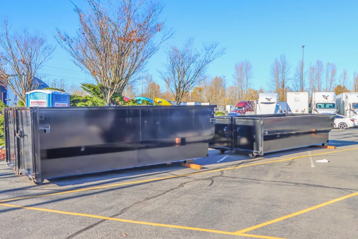 Professional dumpster rental service with roll-off container on residential driveway in Pecan Plantation